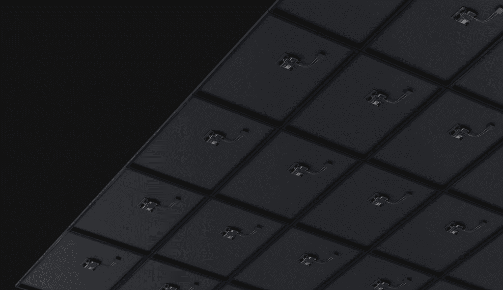 An image of a black wall with a lot of microinverters on it.
