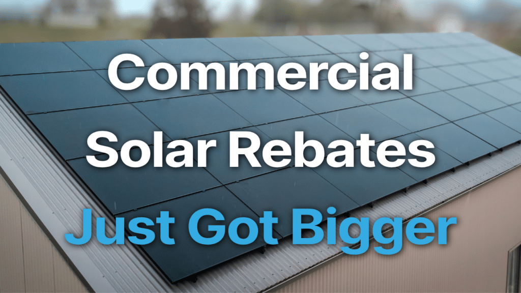 A rooftop with solar panels and the text “Commercial Solar Rebates Just Got Bigger” displayed over the image.