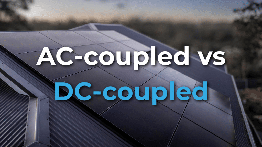 Close-up of solar panels on a rooftop with the text "AC-coupled vs DC-coupled" overlaid in bold white and blue letters.
