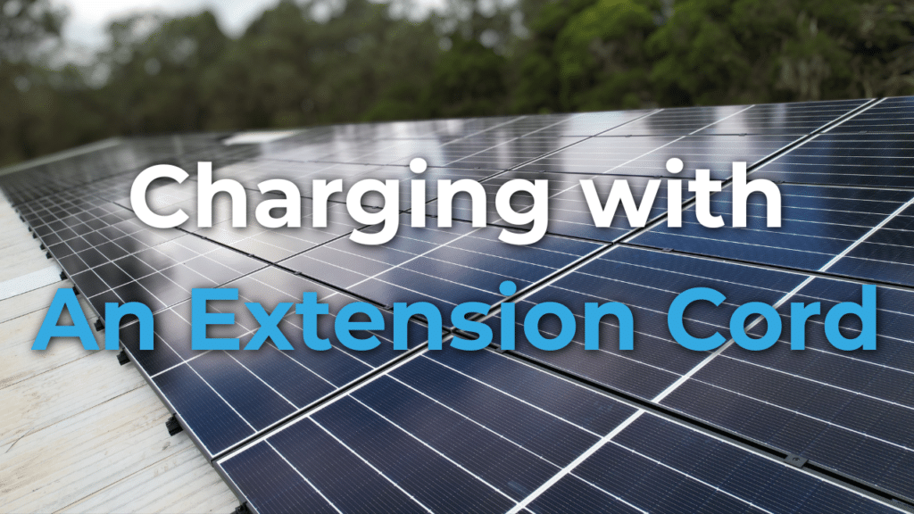 Close-up of solar panels on a rooftop with the text "Charging with An Extension Cord" overlaid on the image.