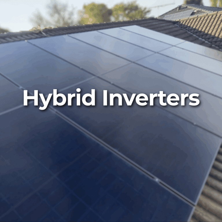 Close-up of solar panels installed on a roof with the words "Hybrid Inverters" overlaid in large white font. Trees are visible in the background.