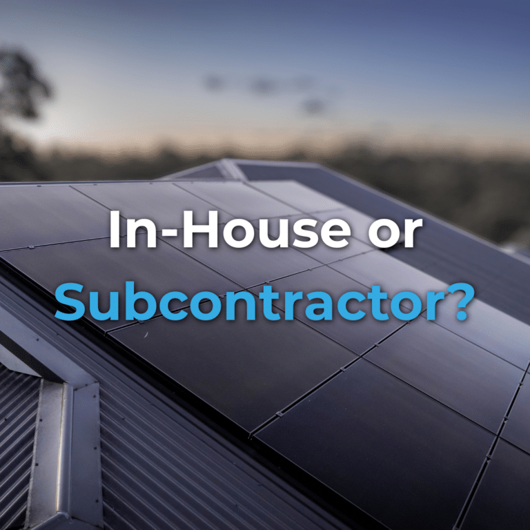 Close-up of solar panels on a roof with the text "In-House or Subcontractor?" overlaid on the image, taken at dusk with a blurred background.
