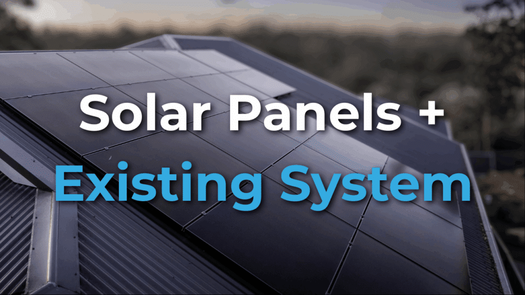 Rooftop solar panels with overlaid text reading "Solar Panels + Existing System" against a blurred outdoor background.
