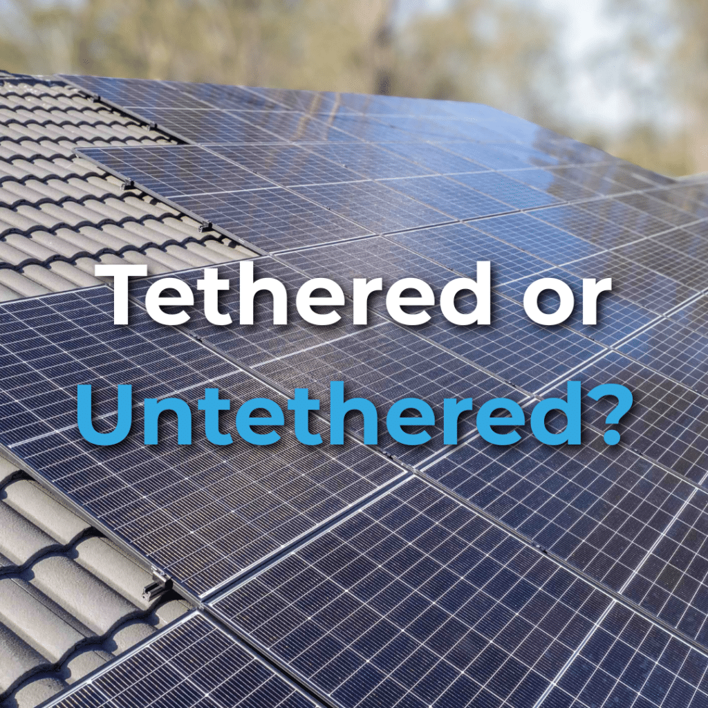 Close-up of solar panels installed on a tiled roof with the words "Tethered or Untethered?" overlaid on the image.
